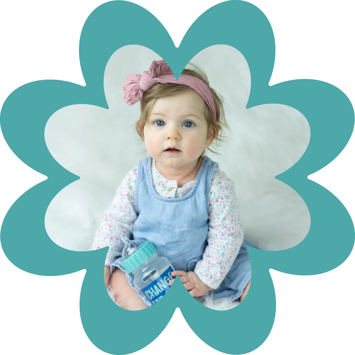 baby girl holding change for life bottle