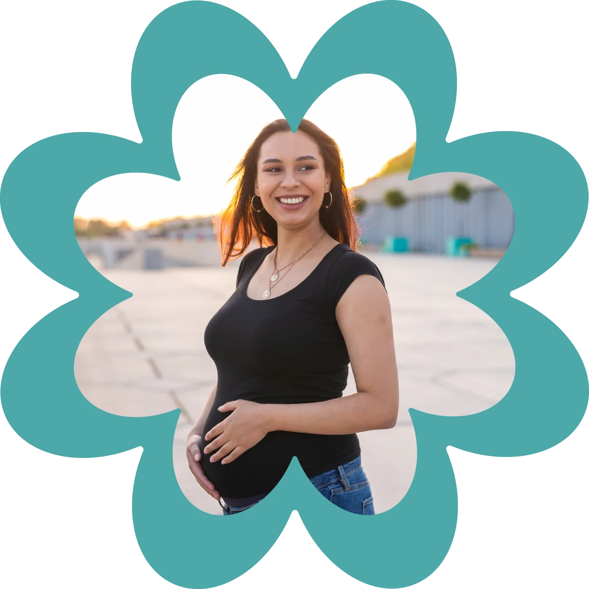 smiling pregnant hispanic woman outside at sunset