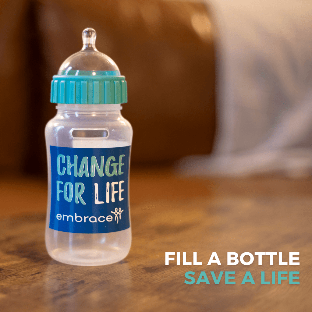 An image with an Embrace Change for Life bottle on a table. The heading reads "Fill a Bottle, save a life."